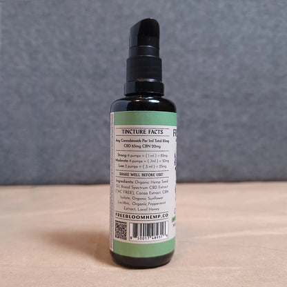 CBD tincture bottle with label on a neutral background