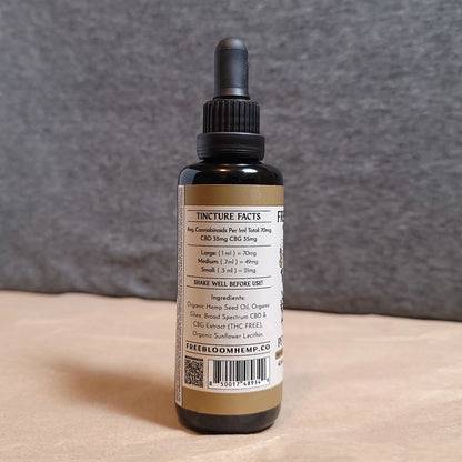 CBD tincture bottle with label on a neutral background