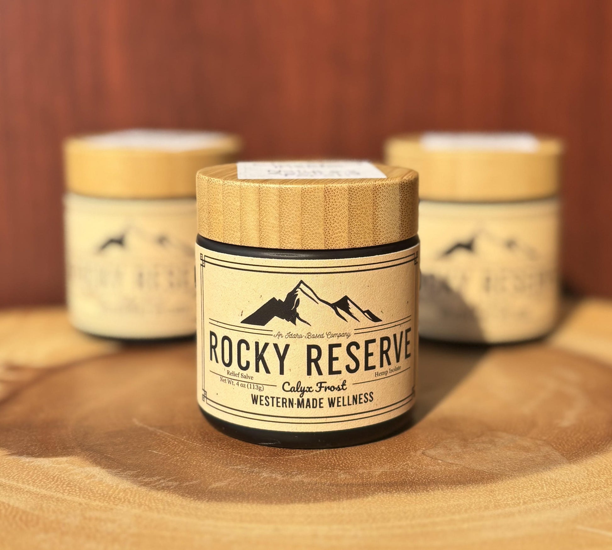 Rocky Reserve - Calyx Frost hemp salve jars on wooden table